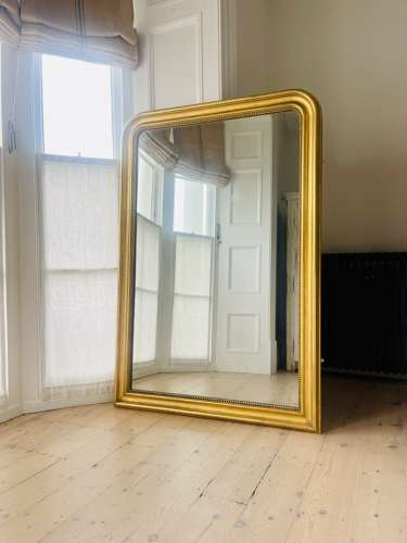 Large antique French gilt leaner mirror