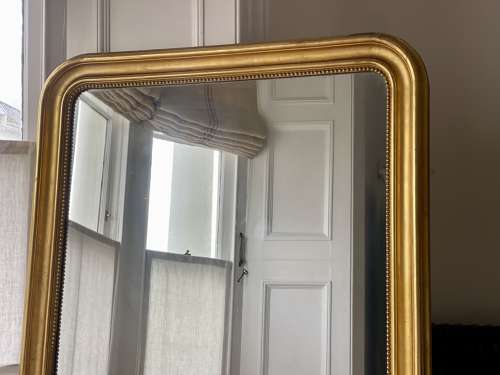 Large antique French gilt leaner mirror