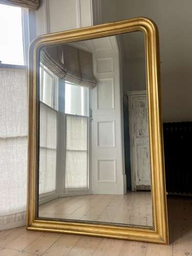 Large antique French gilt leaner mirror