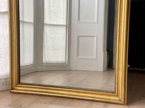 Large antique French gilt leaner mirror