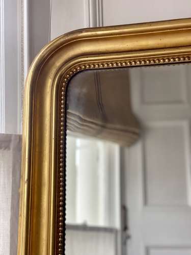 Large antique French gilt leaner mirror