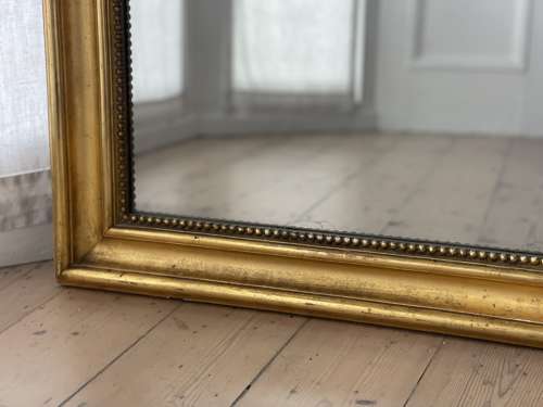 Large antique French gilt leaner mirror